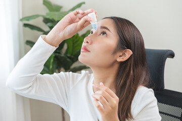 Health care concept, eye problem asian young woman applying, using medical eye drops to treat dry eye and irritation, suffering from irritated eye dry eyes or inflammation, allergy optical symptom.