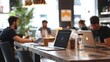 © phurinee - Laptop on Wooden Table in Modern Cafe