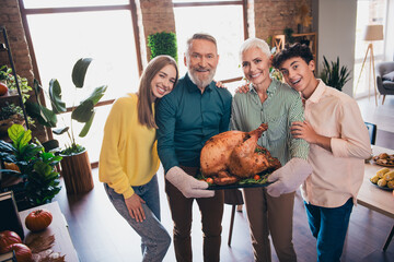 Canvas Print - Portrait of big friendly family embrace hold grilled turkey celebrate thanksgiving day dinner flat indoors