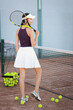 © New Africa - Beautiful woman with tennis racket on court