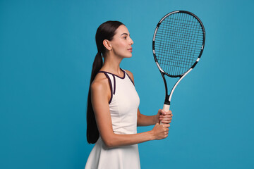 Poster - Beautiful young woman with tennis racket on light blue background