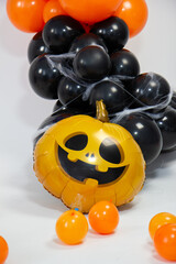 Halloween decorations made of balloons, pumpkin, cauldron and witch's broom