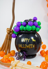 Halloween decorations made of balloons, pumpkin, cauldron and witch's broom