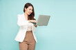 © comzeal - Happy young Asian software engineer businesswoman using laptop computer isolated on green background