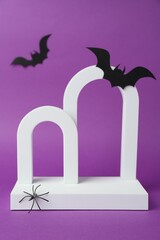 Wall Mural - Presentation of product. Arches and Halloween decor on purple background. Space for text