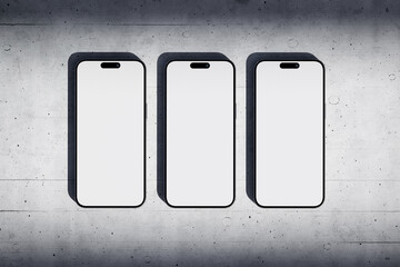 Wall Mural - Three phones with a blank screen on a concrete background