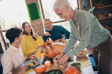 Wall Mural - Photo of cheerful family communicate have fun meeting eating thanksgiving holiday dinner good mood having fun at home indoors