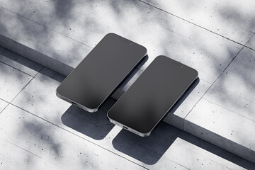 Wall Mural - Two phones with a blank screen on a concrete background