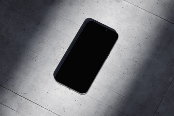Wall Mural - Phone with a blank screen on a concrete background