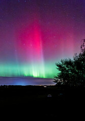 Wall Mural - northern lights dancing over country landscape in noreth of sweden.