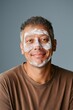 © Andrii Zastrozhnov - A man with a white face paint on his face is smiling. The man is wearing a brown shirt