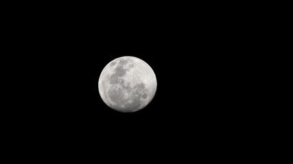 Wall Mural - waning moon. Beautiful moon lights up the night. The moonlight filters through the clouds. A night illuminated by the moonlight. Craters of the moon