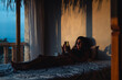 © Luis Herrera/Stocksy - young woman in bed with phone in dark room at dawn