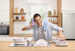 © Ljupco Smokovski - Cheerful young man washing dishes in kitchen