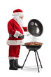 © Ljupco Smokovski - Santa claus cooking meat on a barbecue
