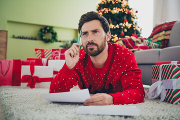 Wall Mural - Photo of nice young man pen letter think ugly sweater christmas atmosphere apartment indoors