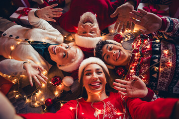 Wall Mural - Top photo of happy smiling family lying wave hands having christmas tree decor ornament santa claus hat in house