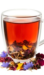 Canvas Print - Floral tea blend in a clear cup with dried flowers surrounding it, emphasizing the natural beauty of herbal tea infusions 