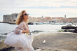 © Boris Jovanovic/Stocksy - Woman strolls at the waterfront of Dubrovnik
