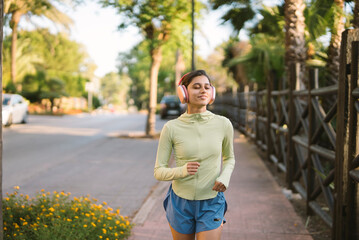 Sticker - A woman is jogging energetically in a stunning and beautiful urban environment today