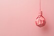 © WhimsyCreative - Creative minimalistic origami light bulb on pastel pink background closeup