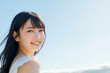 © keisuke - 青空を背景に立つ20代の日本人女性