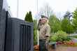 © Raymond Forbes LLC/Stocksy - Senior Citizen military man at war memorial morning