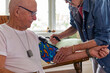 © Raymond Forbes LLC/Stocksy - Veteran home medical Check up for blood pressure