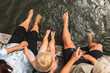 © Diego Martin/Stocksy - Up View of Grandparents Holding Hands with Grandchild on Jetty