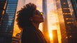 © CinimaticWorks - happy successful Black businesswoman standing in an urban city street at sunset with skyscrapers, dreaming of new investment opportunities and focusing on her successful business vision
