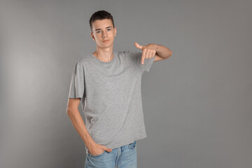 Canvas Print - Teenage boy wearing t-shirt on grey background