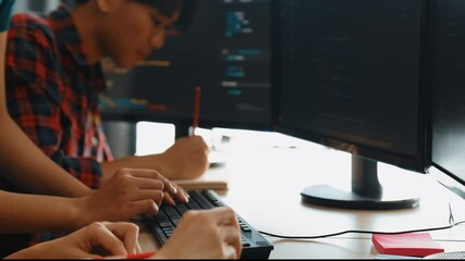 Slow motion back end software developer engineer for computer programming working together on debugging writing computing code, solving complex algorithms display on monitor in office. Burgeoning