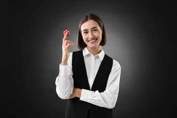 Poster - Croupier with casino chip on black background