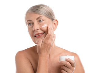 Sticker - Senior woman applying face cream on white background