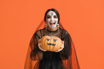 Sticker - Beautiful young woman dressed as dead bride for Halloween party with pumpkin on orange background