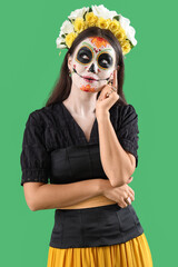 Poster - Thoughtful young woman dressed for Halloween on green background