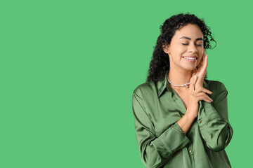 Poster - Beautiful young African-American woman on green background. International Women's Day