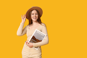 Poster - Stylish young girl with fashion magazine on yellow background