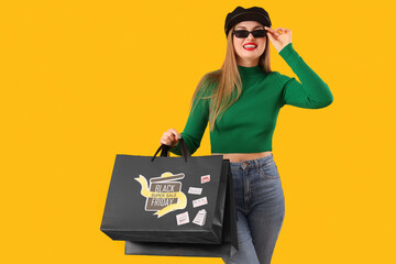 Sticker - Beautiful young happy woman with shopping bags on yellow background. Black Friday sale