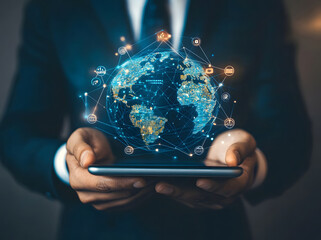 A businessman holds digital icons and smart devices with a global network connection design, showcasing the concept of online technology for business success design