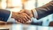 © BISO - Two business professionals shaking hands in a formal setting, symbolizing agreement and partnership.