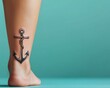 © CHA - This striking image showcases a detailed anchor tattoo on a bare leg, set against a mint background, highlighting the blend of body art and style.