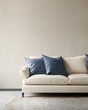 © bcendet - A white sofa with blue cushions against a beige wall.