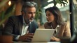 © The Little Hut - Mature 40s age Latin business man mentoring mid age European business woman discussing project on laptop in office Two colleagues group of partners businessman and businesswoman workin : Generative AI