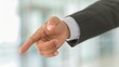 © CrazyJuke - A closeup of a businessmans hand extending for a handshake, with blurred colleagues symbolizing agreement in the background.