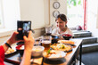 © Diego Martin/Stocksy - Happy Kid Eating in Korean Restaurant