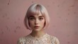 © R-CHUN - ethereal portrait of a pixielike woman with platinum bob against a pastel pink backdrop delicate features and wideeyed innocence evoke a whimsical fairytale quality.