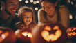 © Curioso.Photography - Children happily carving and lighting jack-o'-lanterns together for Halloween.