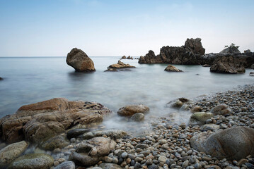 Wall Mural - Long exposured photography of sea waves on the rocky beach at Haesindang Park near Samcheok-si, Korea