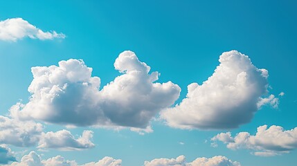 Wall Mural - close-up of puffy white clouds drifting across a bright blue sky